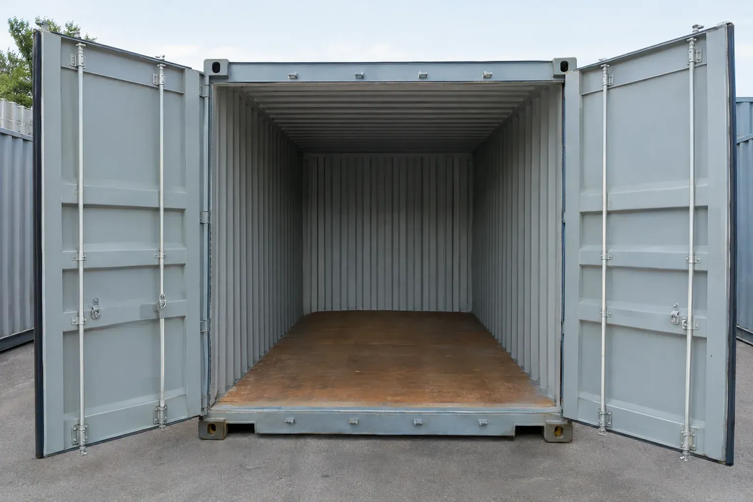 Open cargo doors at the end of a container showing the empty interior