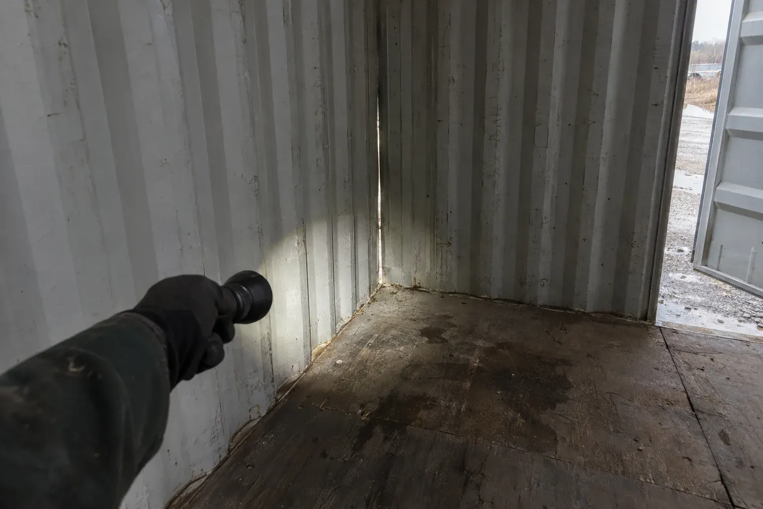 Checking the inside of a container for daylight with a flashlight